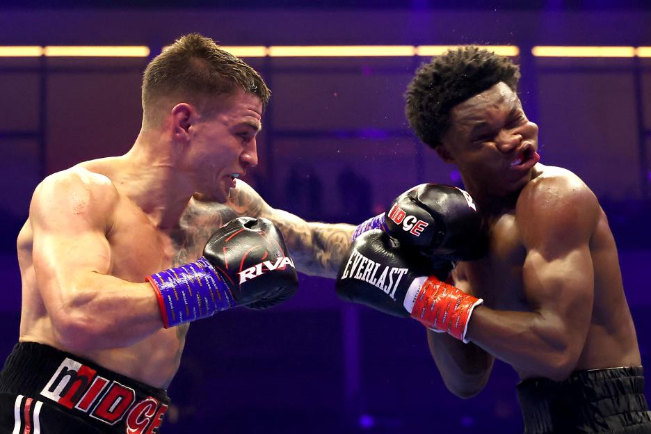 Sam Noakes punches Abdullah Mason in a WBO lightweight title fight.