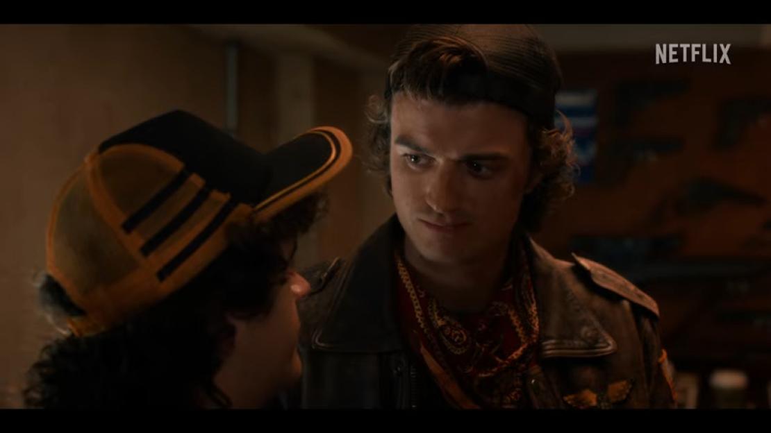 Steve and Dustin from Stranger Things looking at each other.