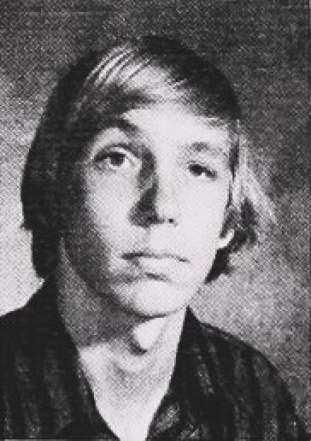 Headshot of Douglas Gretzler, a man with shoulder-length hair looking directly at the camera.
