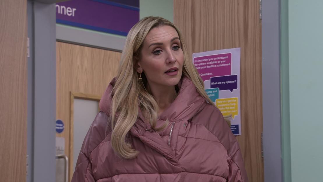 Eva Price (Catherine Tyldesley) appears in the doorway.