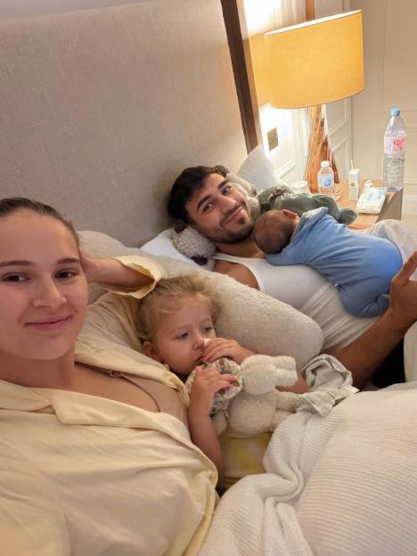 Molly-Mae, Tommy, and their children, Bambi and Midas, in bed together.