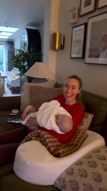 Sophie Habboo smiles while holding baby Ziggy.