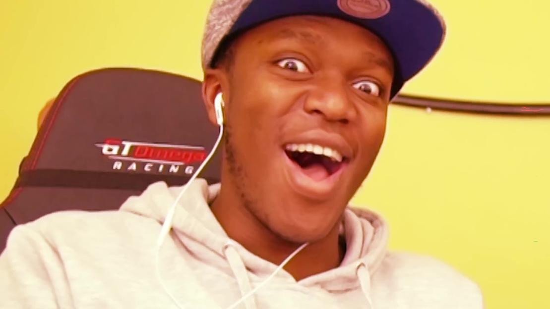KSI with a shocked expression, wearing a gray hoodie and blue cap.