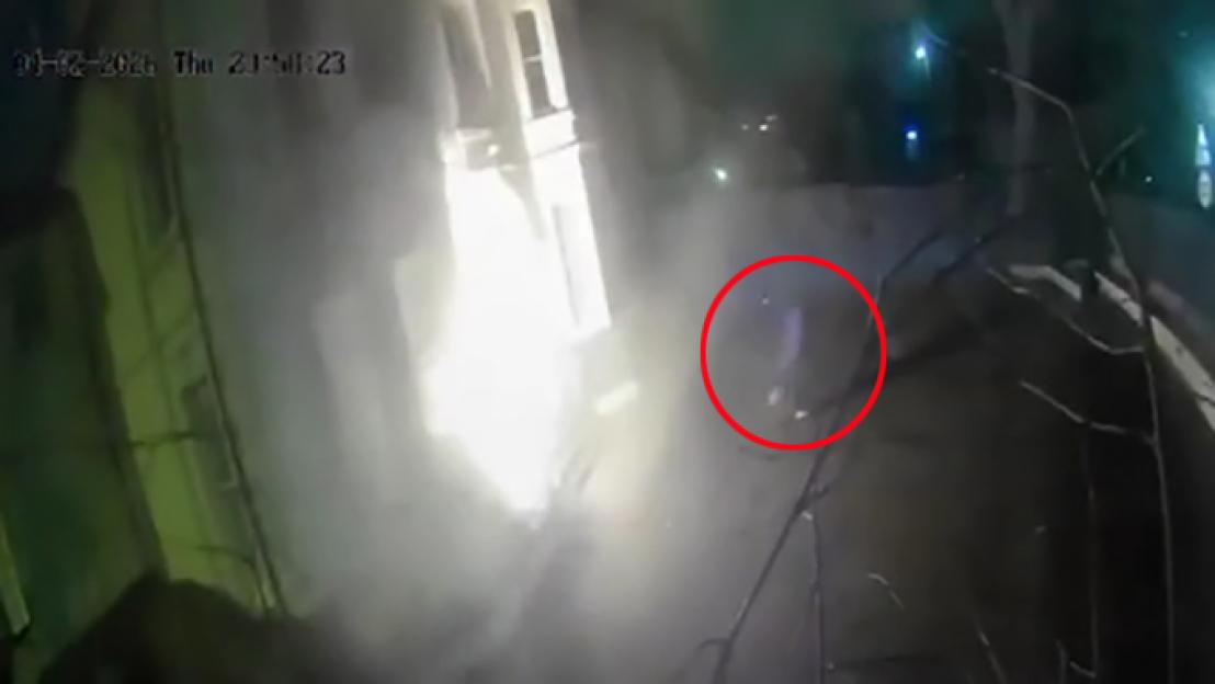 CCTV footage shows a person throwing a petrol bomb at a building.
