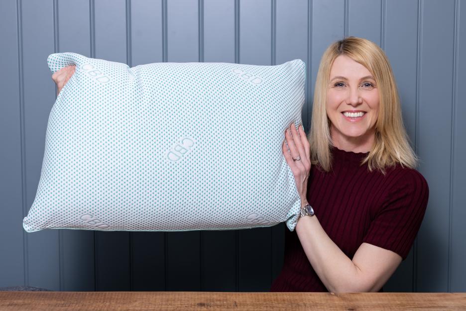 Woman holding an Aldi CBD pillow.