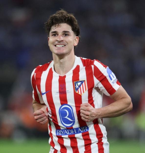 Rodrigo Riquelme of Atletico Madrid smiles while wearing his red and white striped jersey during a match.
