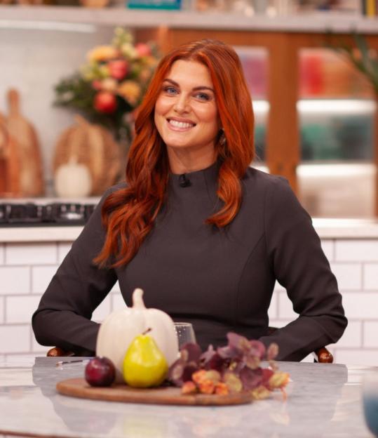 Woman with red hair smiling at the camera on the "This Morning" TV show.