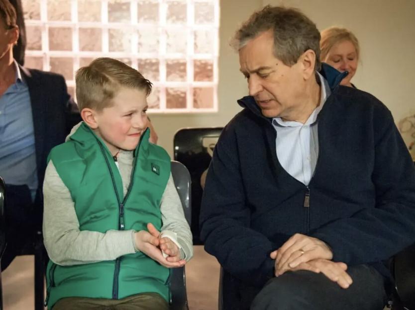 Alfie Clarke sitting next to an older man.