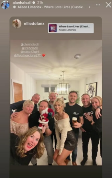 A group of eight people, including Alan Halsall and his girlfriend, posing for a photo.