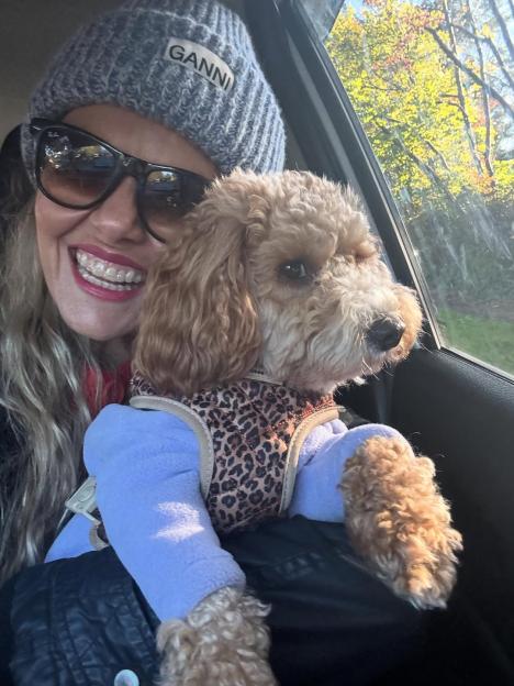 Charlie Brooks in a car with her dog.