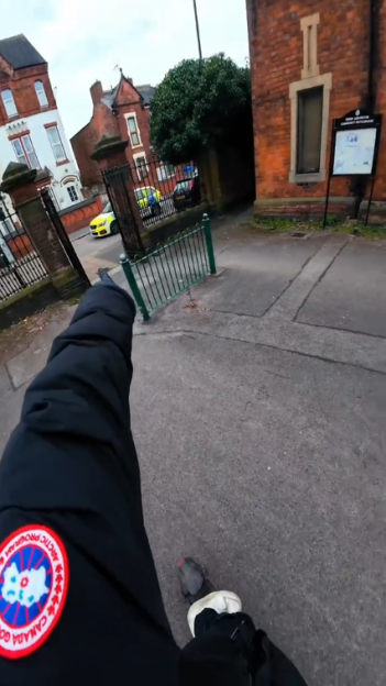 Person on an e-scooter pointing towards a police car.