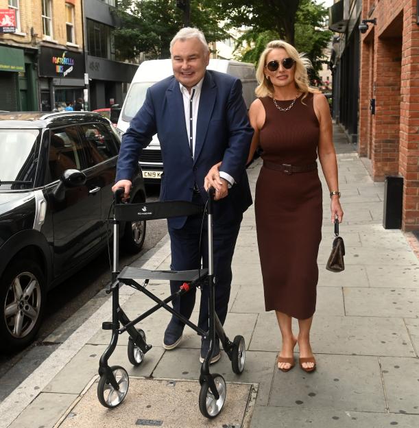 Eamonn Holmes and Katie Alexander walking together, Holmes uses a walker.