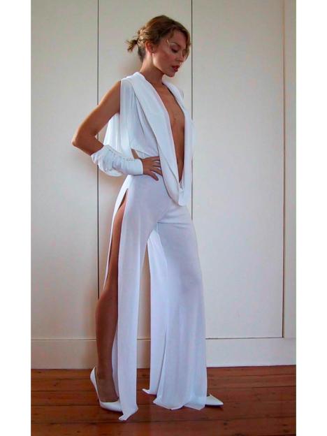 Kylie Minogue in a white plunging jumpsuit with thigh-high slits.