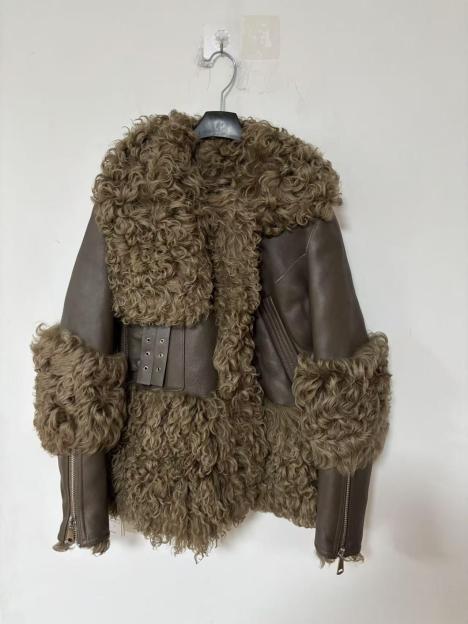 Brown fur coat with a large fur collar and fur cuffs, hanging on a metal hanger.