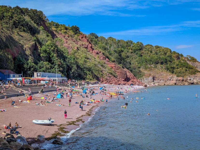 Busy beach at Oddicombe in Torquay on a hot summer's day.