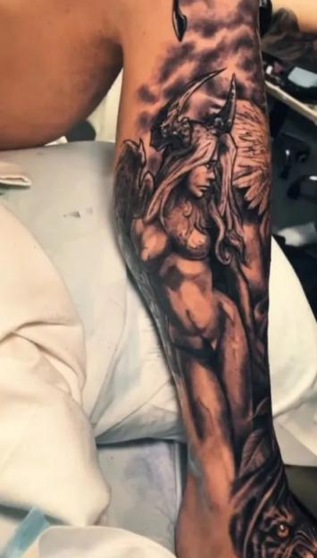 a tattoo of a woman with horns and wings on her arm