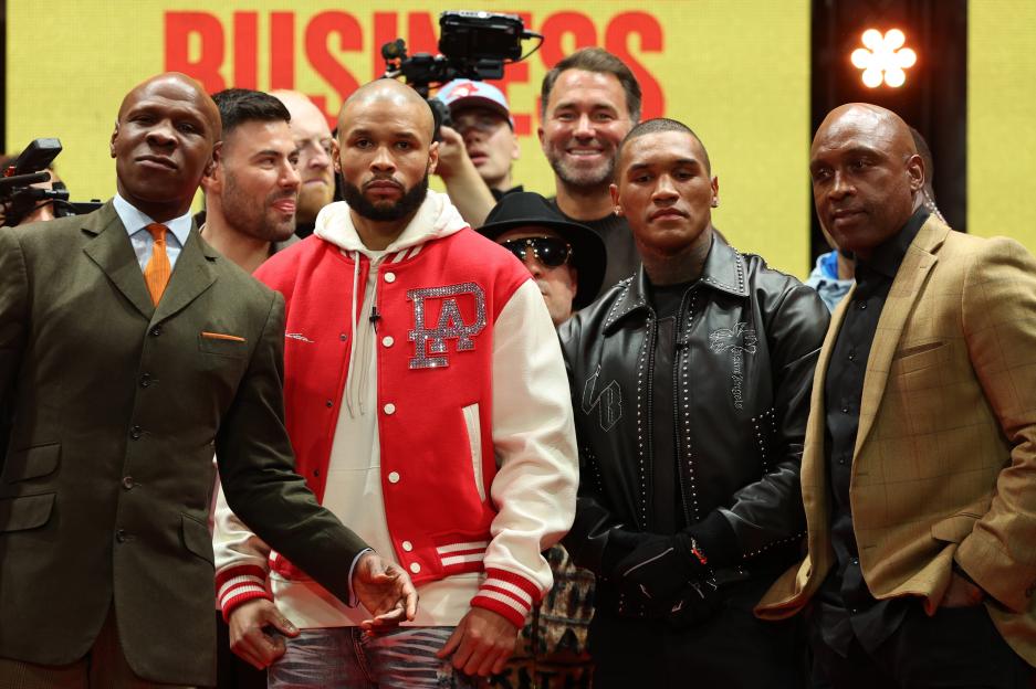 Chris Eubank Jr. and Conor Benn pose with their fathers at a press conference.