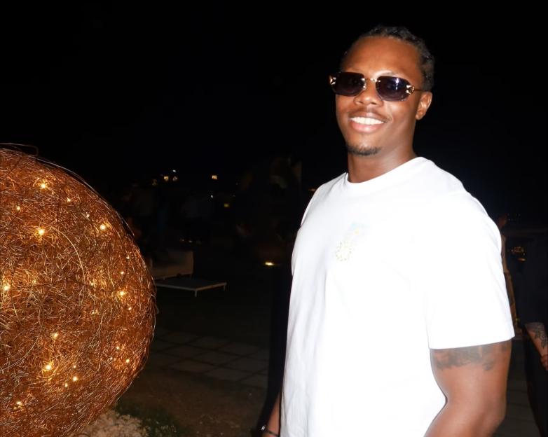 Daniel Manuel smiling and wearing sunglasses.