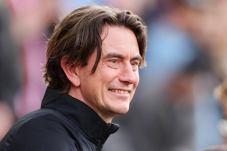 Head coach Thomas Frank smiling.