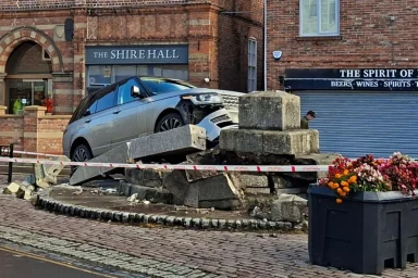 Range Rover demolishes quiet town’s historic cross in crash as pedestrian taken to hospital