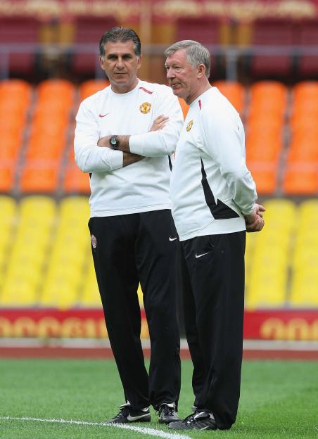 Carlos Queiroz and Sir Alex Ferguson on a soccer field at the Luzhniki Stadium.