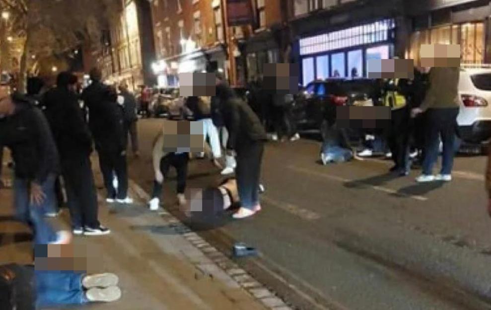 People attending to injured individuals lying on the street after a car drove into pedestrians.