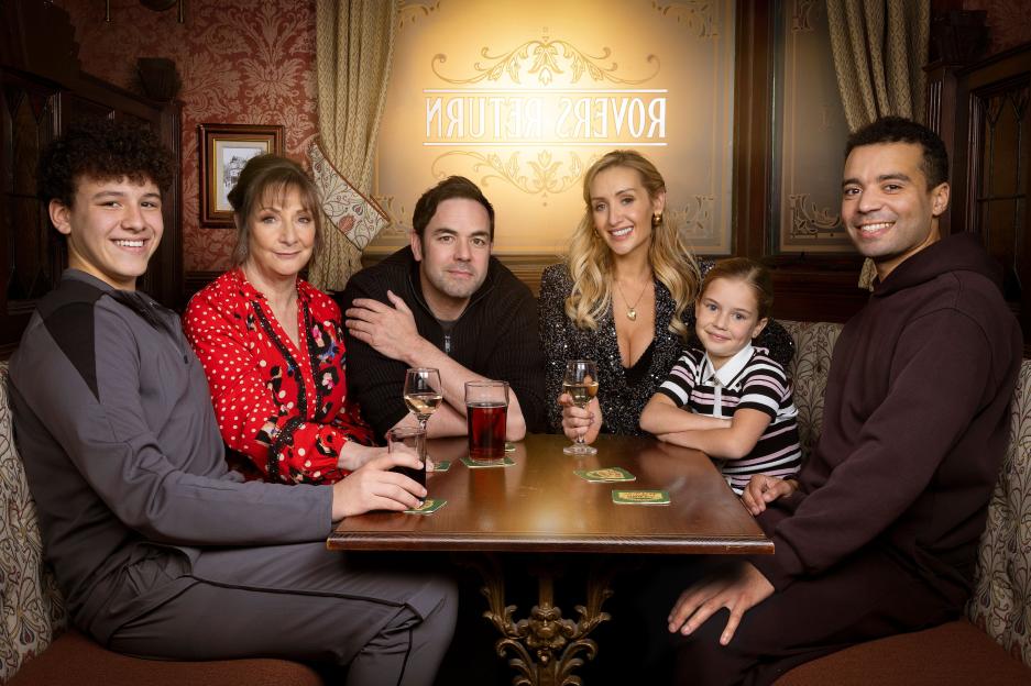 The Driscoll family sitting at a table with drinks in a pub.