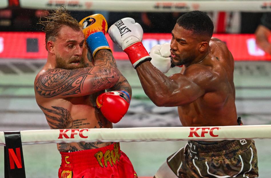 Jake Paul (L) and Anthony Joshua box in a non-title heavyweight bout.