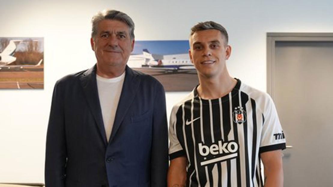 Football manager and player in black and white striped jersey standing next to each other.