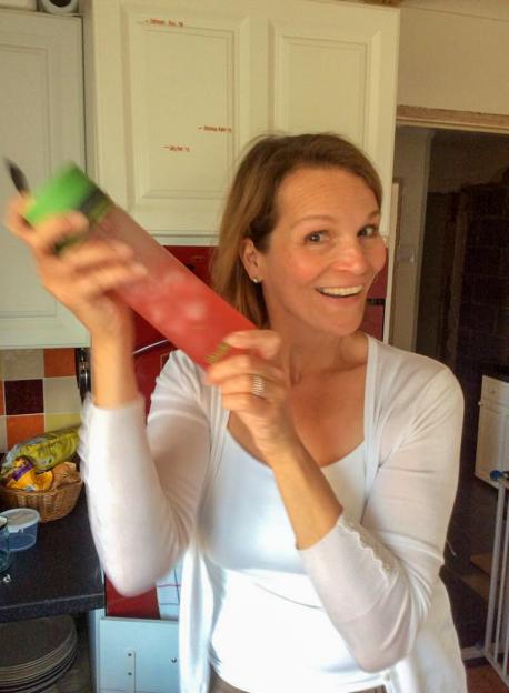 Claire Bridger, 64, holding a shaker and smiling.