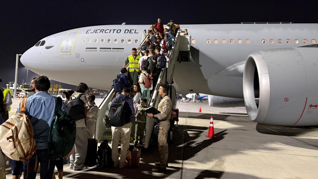 Spanish nationals, who are trapped in the Middle East amid the U.S. and Israeli conflict with Iran, board a military repatriation flight at an unknown location in Oman
