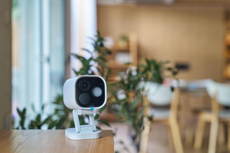 Modern wireless security camera monitoring a cozy living room