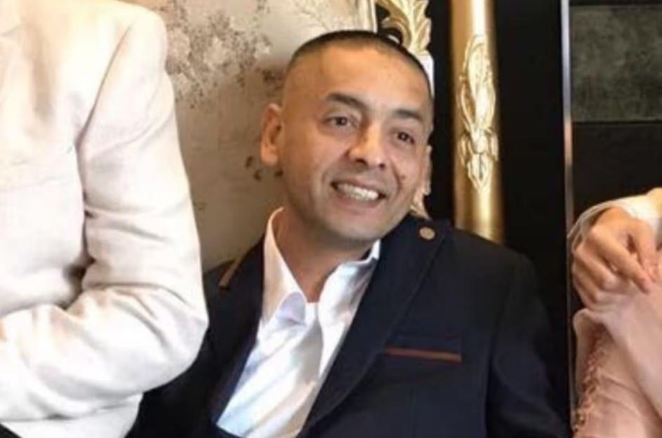 IMRAN, a smiling man with a shaved head, wearing a dark suit and white shirt.