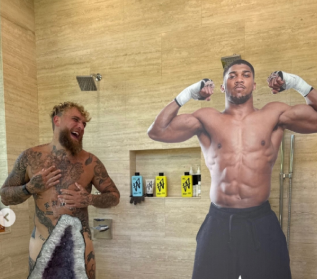 Jake Paul and Anthony Joshua in a shower.
