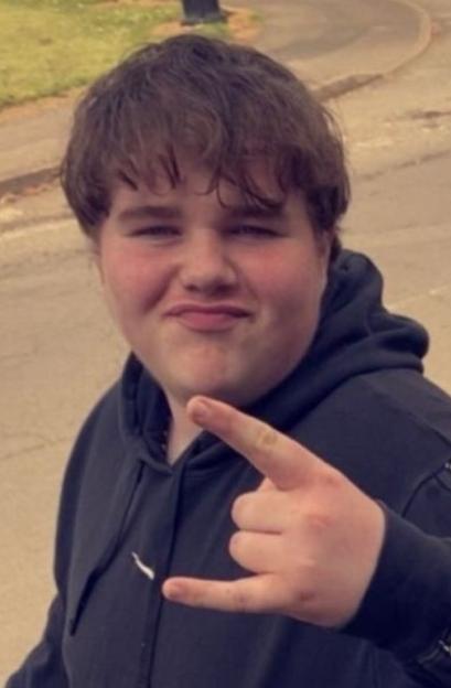 Trevor Wynn, a 17-year-old boy, looks at the camera while making a hand gesture.
