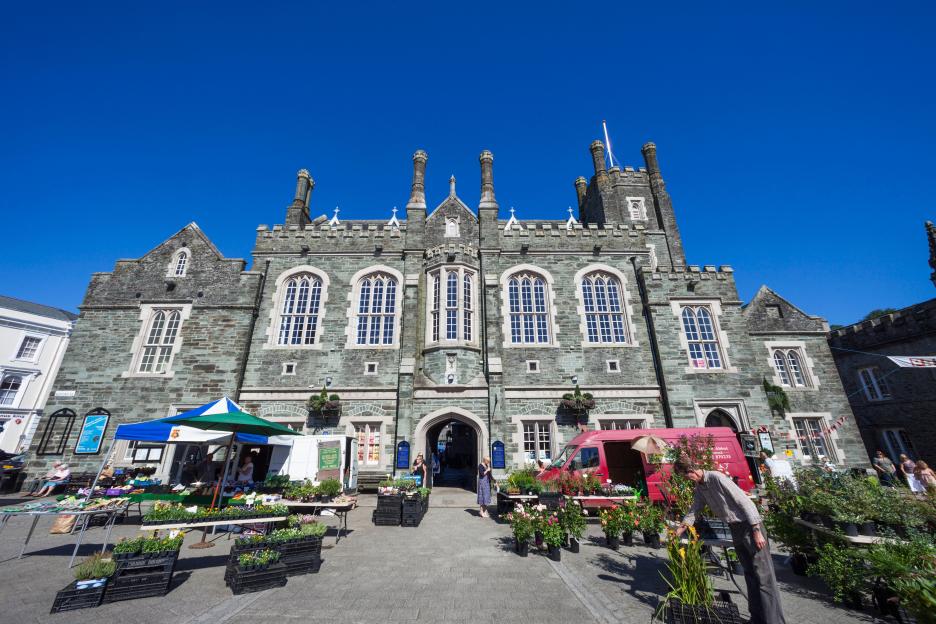 Tavistock Town Hall, England, with an outdoor market in front.