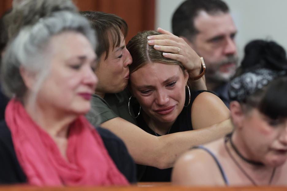 Dylan Mortensen receives a hug after speaking at Bryan Kohberger's sentencing hearing.
