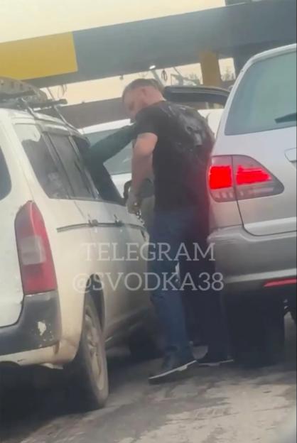 Russian motorists fight at petrol stations amidst growing fuel crisis caused by Ukrainian strikes on Vladimir Putins oil refineries. As tempers fray, a man beats up someone in the car in the queue to a petrol station in Irkutsk.
