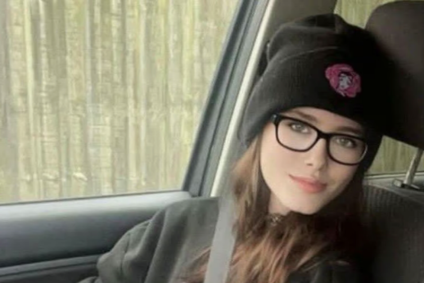 Jamie-Lea Biscoe, a young woman wearing glasses and a beanie, poses for a photo inside a car.
