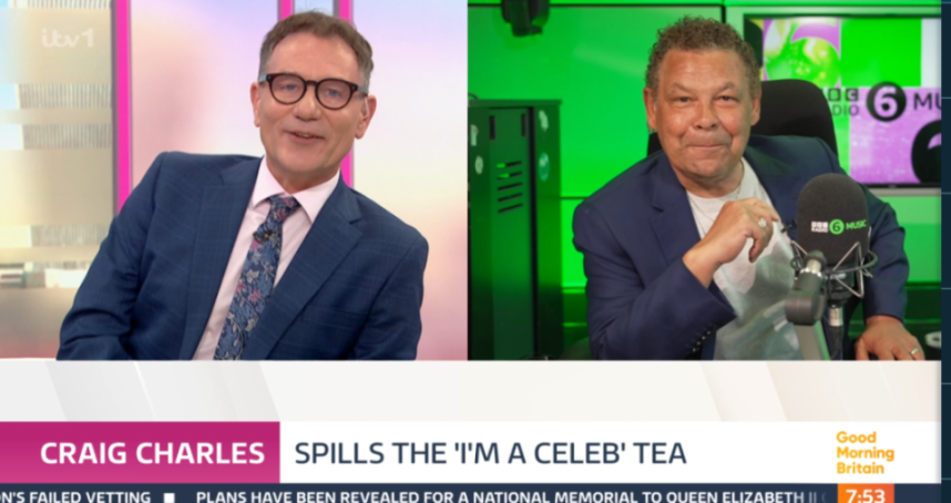 Two men in suits, one with glasses, on a split screen with the text "CRAIG CHARLES SPILLS THE 'I'M A CELEB' TEA".