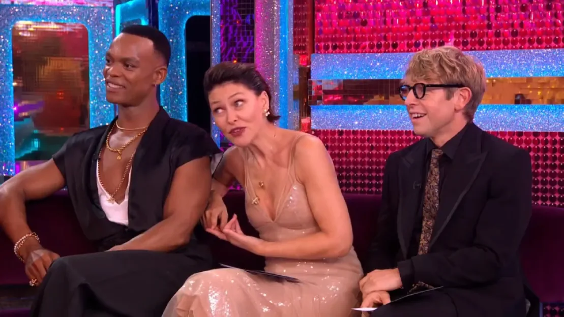 Three people sitting on a purple couch.