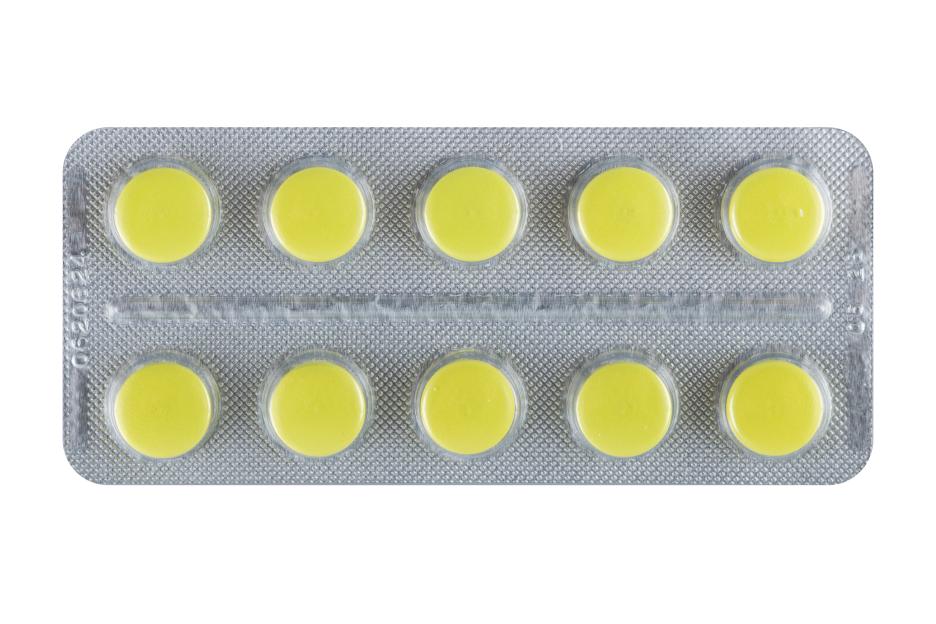 yellow pills tablets in blister pack isolated on white background