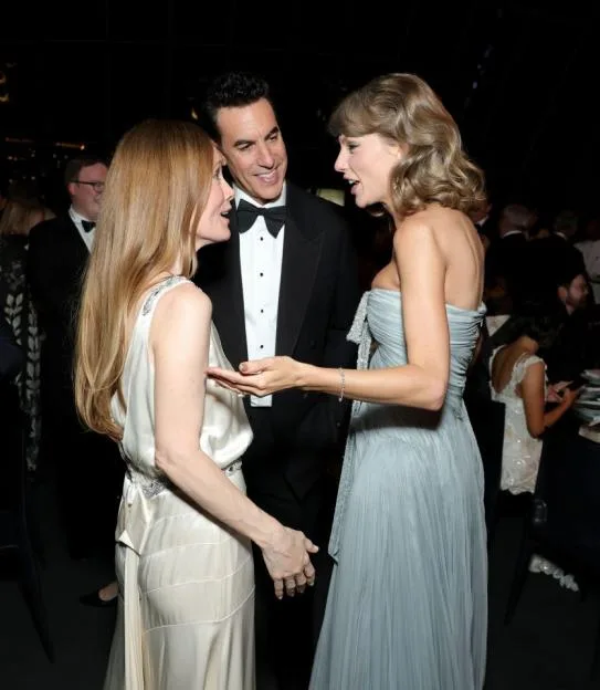 Leslie Mann, Sacha Baron Cohen, and Taylor Swift conversing at the Academy Museum Gala.