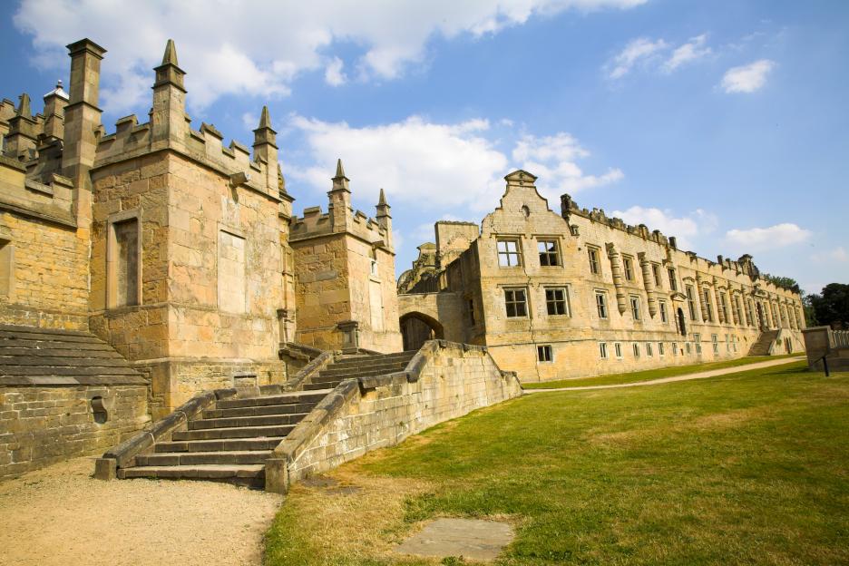 Bolsover Castle in Derbyshire, England, founded in the 12th century, with its stone walls, multiple windows, and exterior staircase.