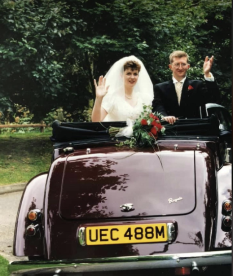 Alison McCormick and William 'Pat' McCormick waving from a car on their wedding day.