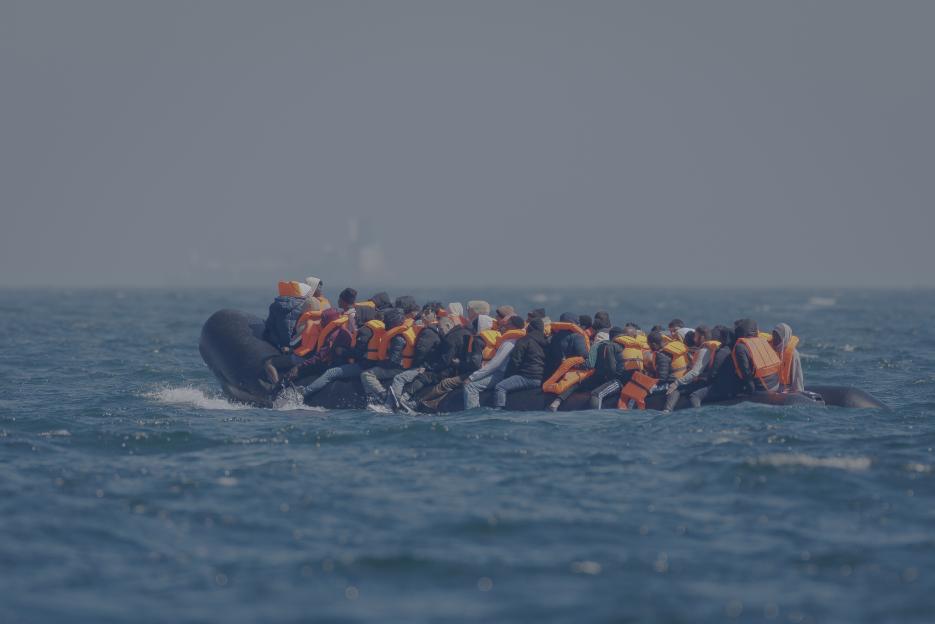 Afghan national Mohammad Tajik piloting a small boat on the English Channel.