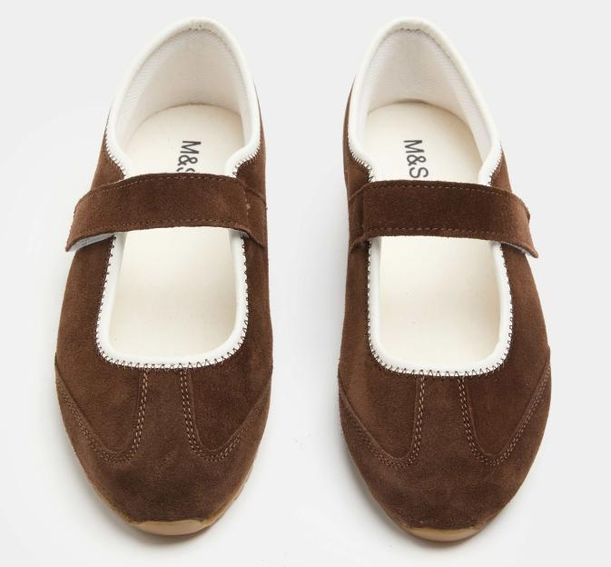 A pair of brown suede M&S mary jane shoes with white trim and velcro straps.