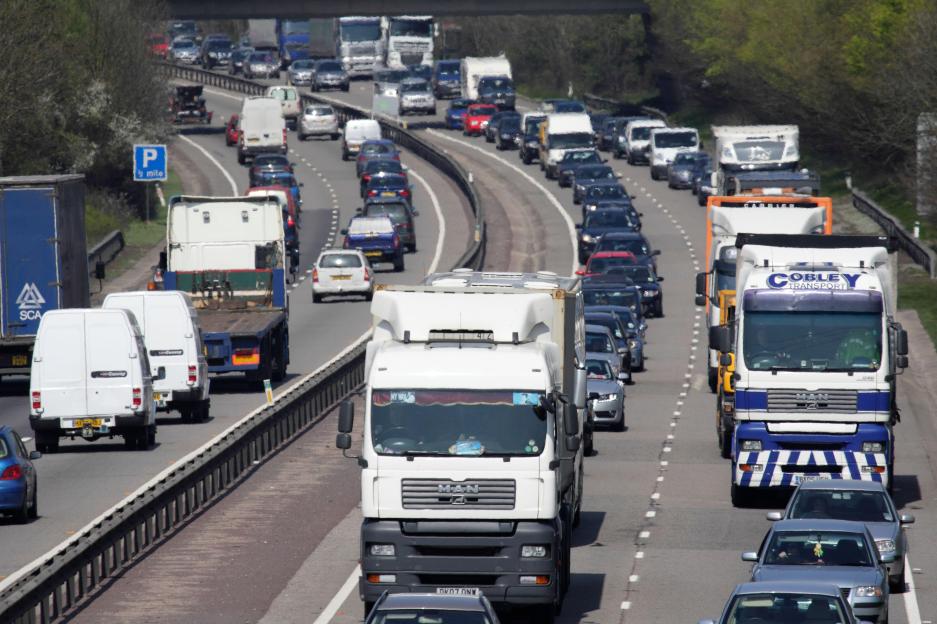 Heavy traffic with trucks, cars, and vans on the A34 highway outside Oxford.