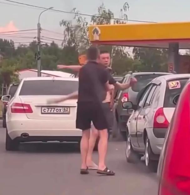 Russian motorists fight at petrol stations amidst growing fuel crisis caused by Ukrainian strikes on Vladimir Putins oil refineries.. Two men fight in the queue at a petrol station in Ryazan.