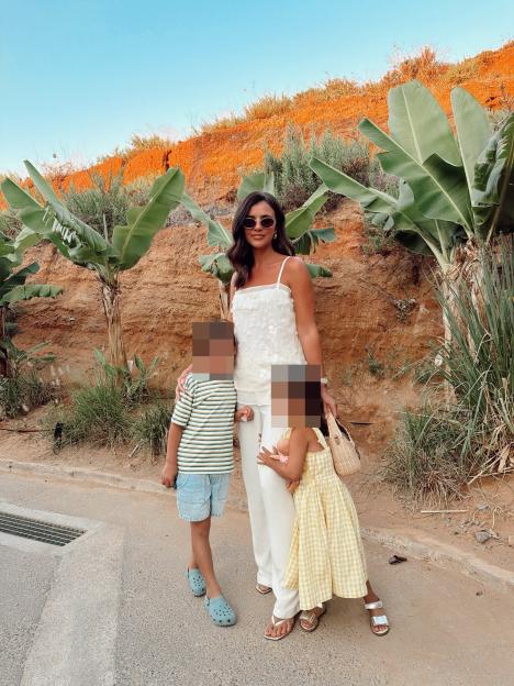 Lucy Mecklenburgh standing with her two children outdoors.